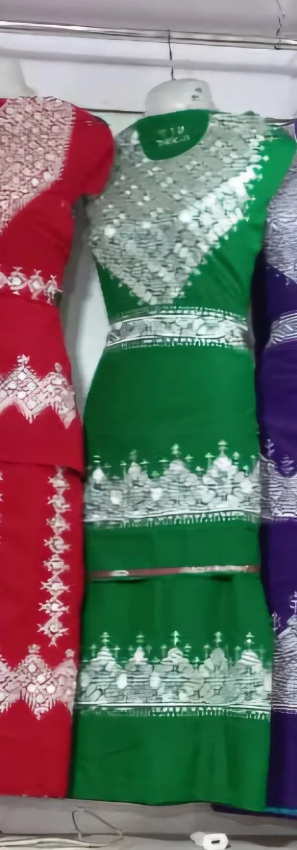 A beautifully handcrafted Hazaragi dress adorned with intricate embroidery, beadwork, and vibrant patterns. Made from luxurious fabric, the dress reflects the rich cultural heritage and artisanal skills of the Hazara people.